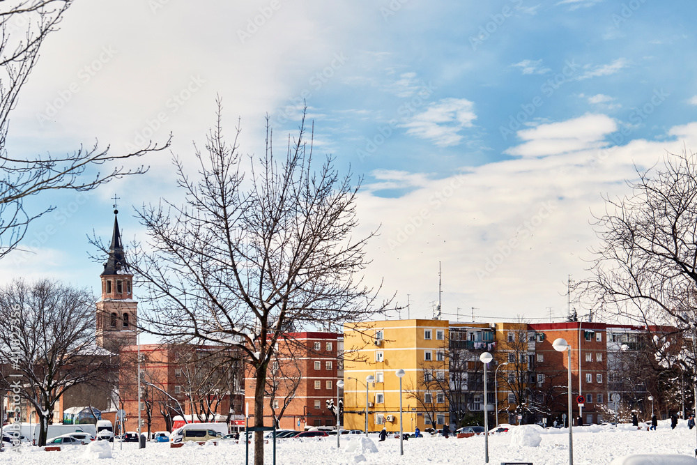 Fototapeta premium Snowy view of the Parroquia San Pedro Ad Vincula Madrid from Sierra Gorda street. Tormeta 