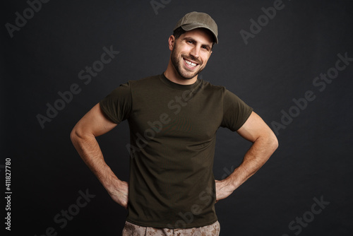 Happy masculine soldier man military and looking at camera