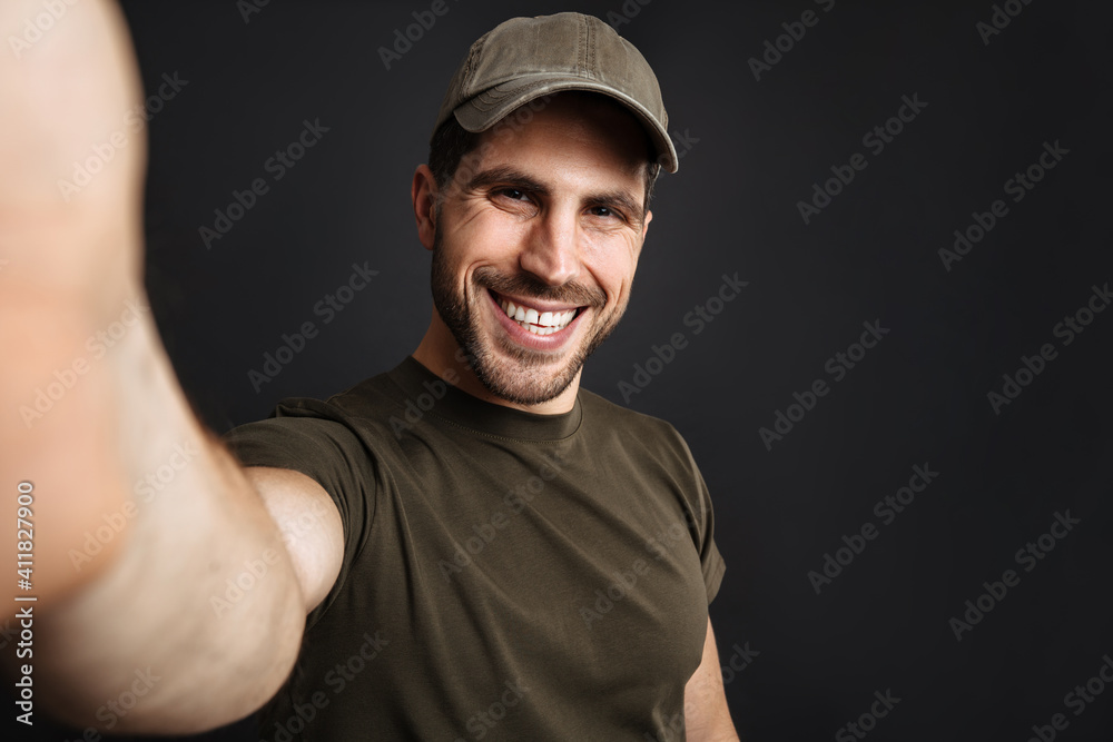 Happy handsome military man smiling while taking selfie photo