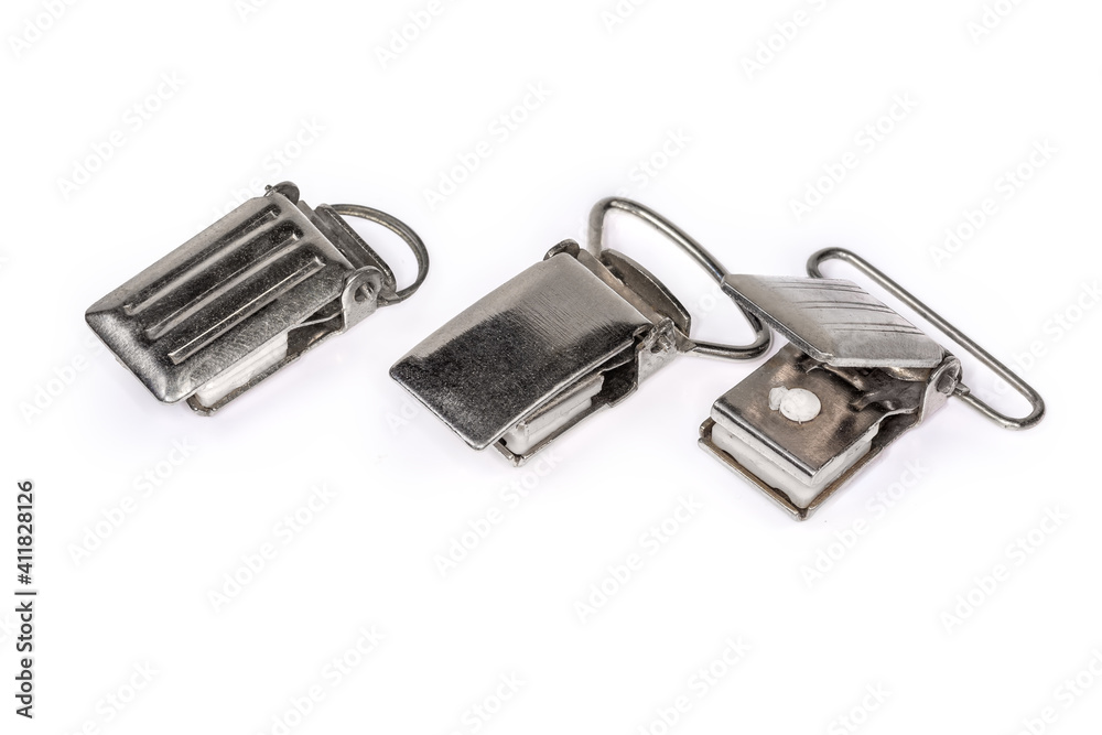 Different old clips for suspenders on a white background Different old clips for suspenders on a white background