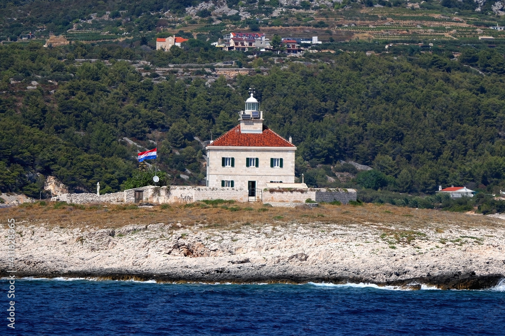 Picturesque lighthouse on small island near Hvar, Croatia.