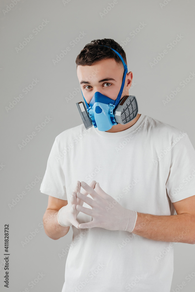 Man wearing full-Face Respirator protective gas mask against virus, radiation, bacteria and dust. Professional mask shortage during Covid-19 Coronavirus SARS-CoV-2 pandemic worldwide outbreak