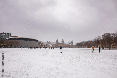 winter view of the white Museumplein or Museum square under the snow in Amsterdam, The Netherlands