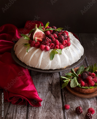 Pavlov's airy dessert decorated with berries. Meringue and meringue with fruit photo