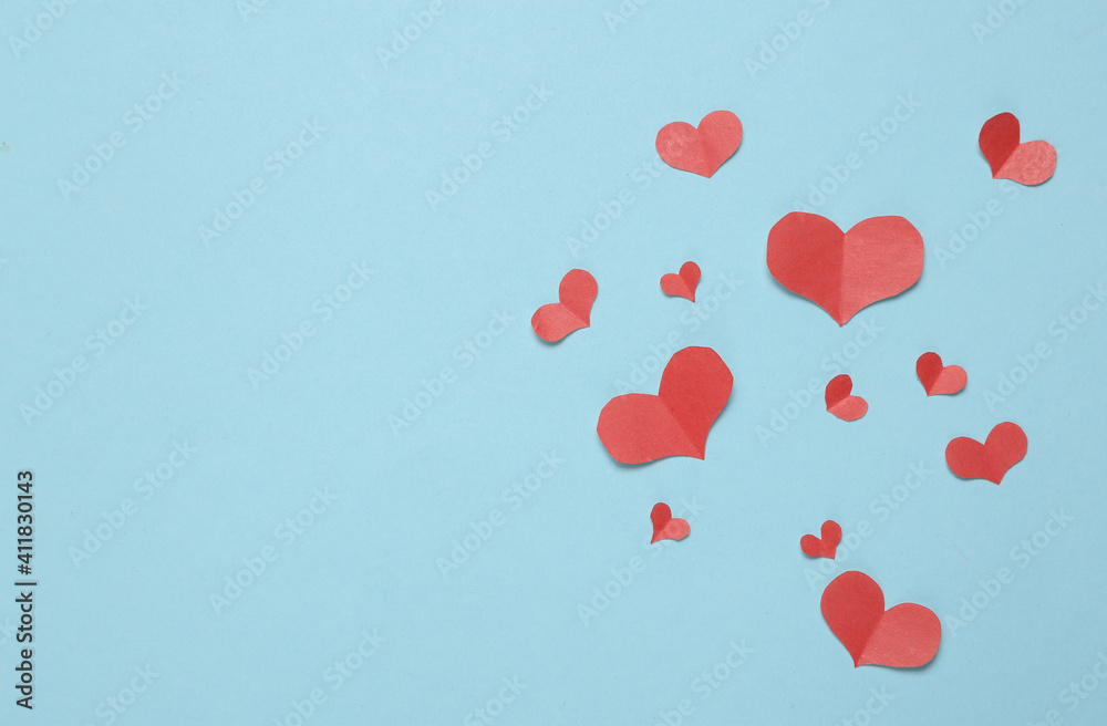 Paper Cut Red hearts on blue background. Copy space