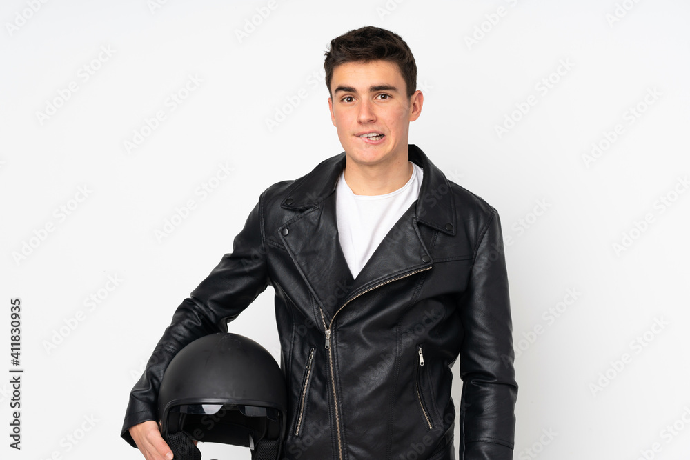 Man holding a motorcycle helmet isolated on white background having doubts and with confuse face expression Man holding a motorcycle helmet isolated on white background having doubts and with confuse face expression