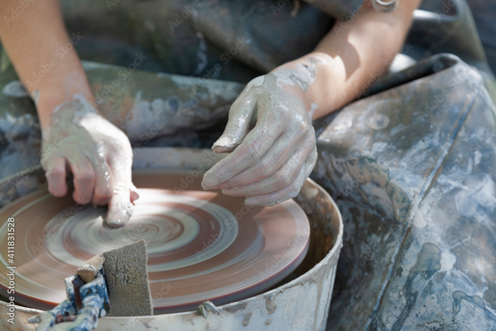 Hands of Potterwork with pottery wheel Hands of Potterwork with pottery wheel