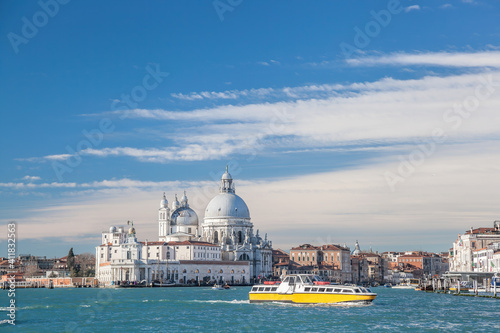 Grand Canal with tourist boat against Basilica Santa Maria della Salute in Venice, Italy