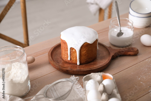 Traditional Easter cake and ingredients on wooden table indoors