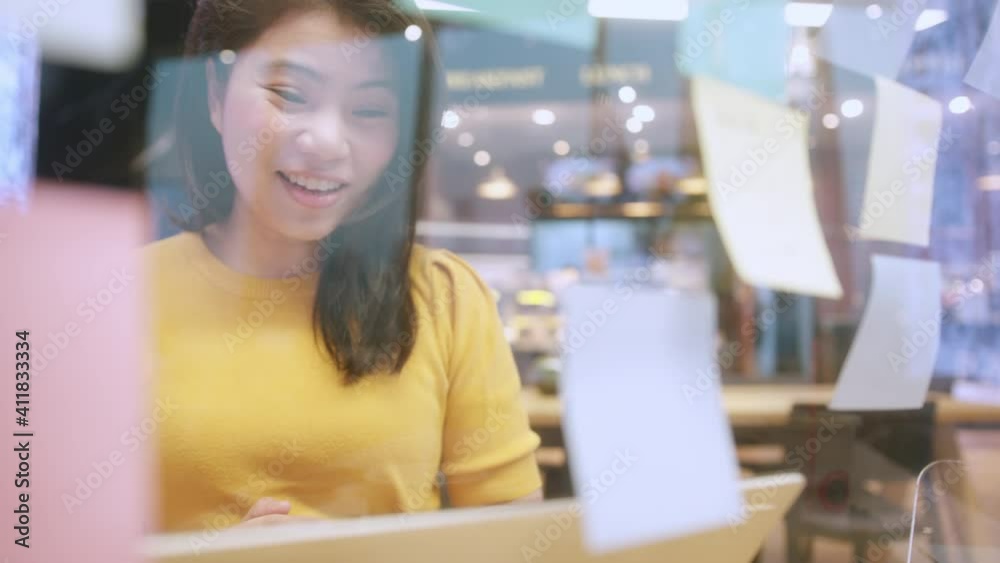 creative agency asian female video conference online meeting working with laptop at coworking area office space with freshness with blur office background creative agency asian female video conference online meeting working with laptop at coworking area office space with freshness with blur office background