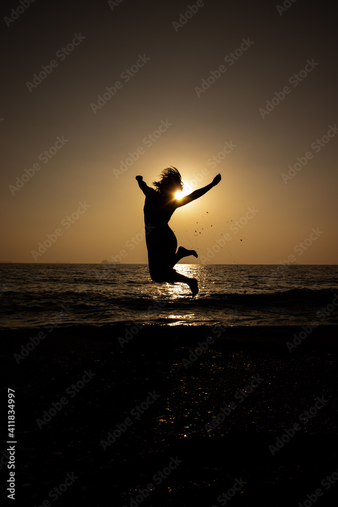silhouette of a person jumping on the beach silhouette of a person jumping on the beach