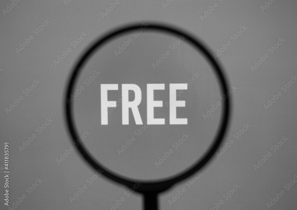 Word free on grey screen through magnifying glass. Word free on grey screen through magnifying glass.