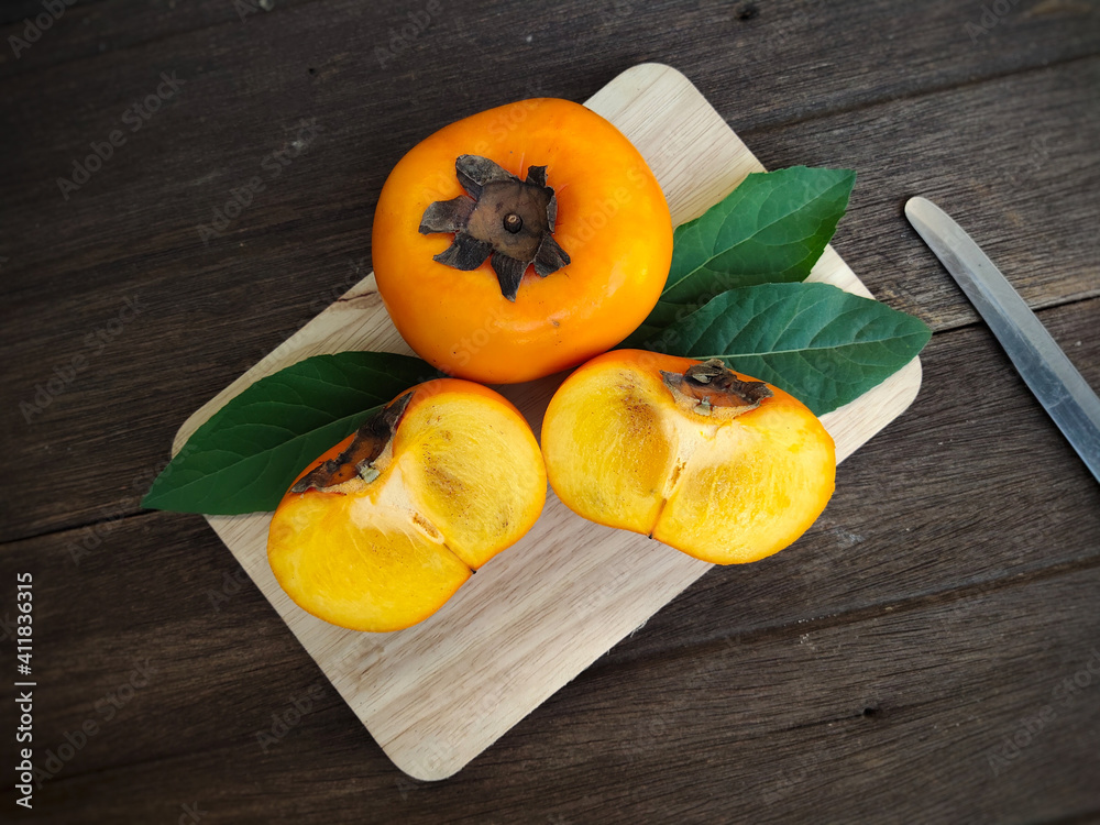 persimmon on wooden table