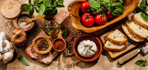 Ingredients for Salad with Burrata cheese and Tomatoes on travertine background