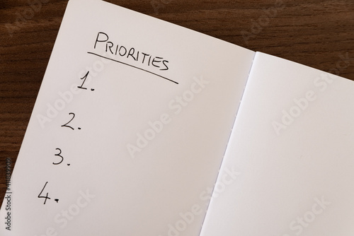 Notebook page marked 'Priorities' in black ink on white paper. photo