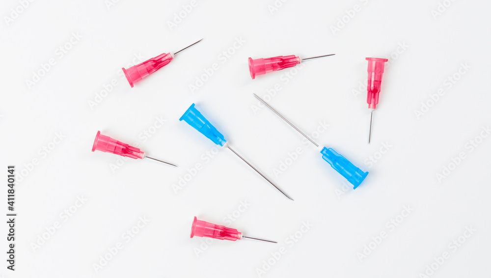 Red and blue needles from syringe. Vaccine and health concept. Addiction to drug addiction. Red and blue needles from syringe. Vaccine and health concept. Addiction to drug addiction.