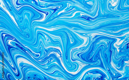 Free flowing blue and white acrylic paint. Random Waves and Curls. Abstract marble background or texture.