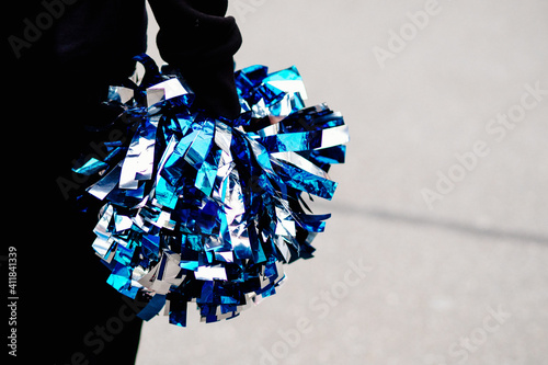 Cheerleader with pompoms during game