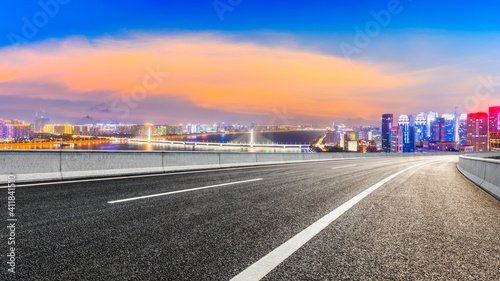 Asphalt road and modern city skyline with buildings in Hangzhou at night. © ABCDstock