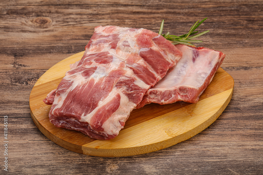 Raw pork ribs served rosemary