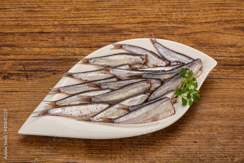 Anchovies in the bowl served basil leaves