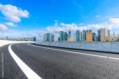 Empty asphalt road and modern city skyline with buildings in Hangzhou.