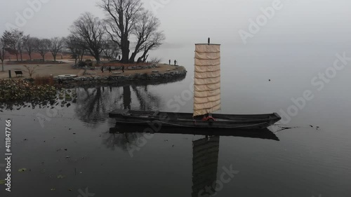 VDO 4k Sailboat in a swamp amid the mist at Dumulmeori, Yangsu Township in Seoul, South Korea. photo