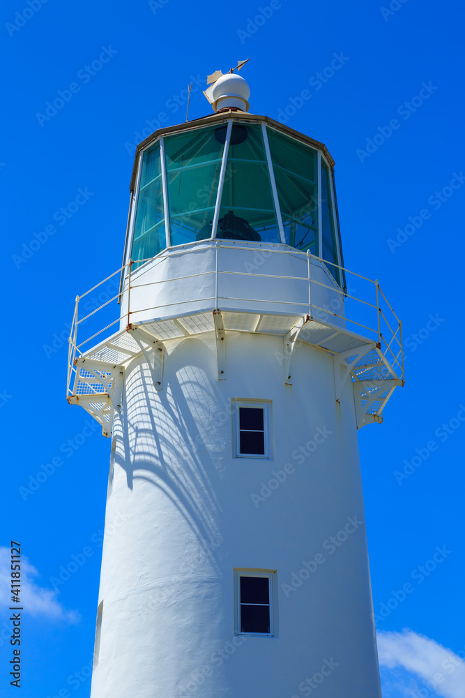 The top of an old lighthouse against a blue sky. Historic Cape Egmont Light, Taranaki, New Zealand