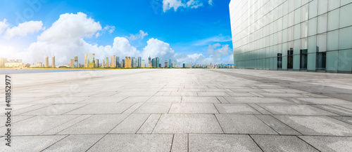 Empty square floor and modern city skyline with buildings in Hangzhou.