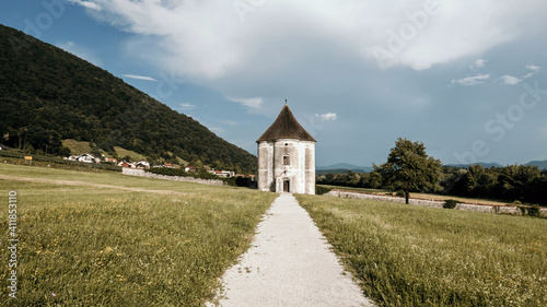 Gravel path leading to medieval pavilion in field. Hudicev turn, Slovenia photo