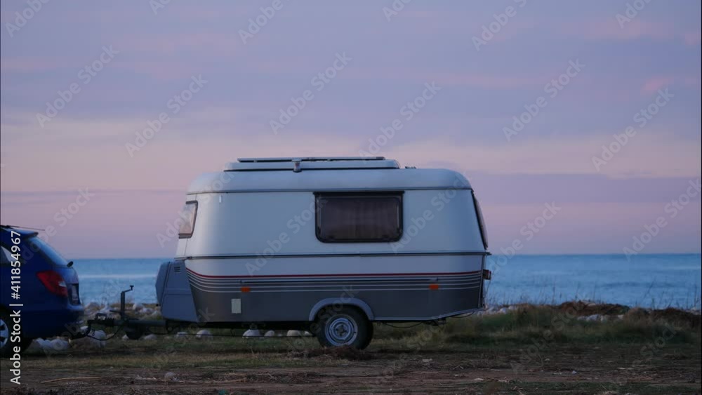 Caravan, recreational vehicle camping on seaside meadow field at sunrise. Capi Corb location, Valencia, Mediterranean coast of Spain. Traveling by motorhome. Caravan, recreational vehicle camping on seaside meadow field at sunrise. Capi Corb location, Valencia, Mediterranean coast of Spain. Traveling by motorhome.