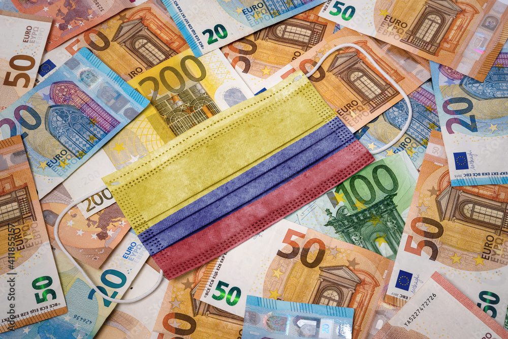 Medical mask with the flag of Colombia on a variety of european banknotes.(series) Medical mask with the flag of Colombia on a variety of european banknotes.(series)