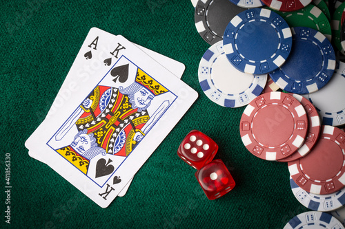 Fotografie Stack of chips and two aces on the table on the green baize - poker game concept
