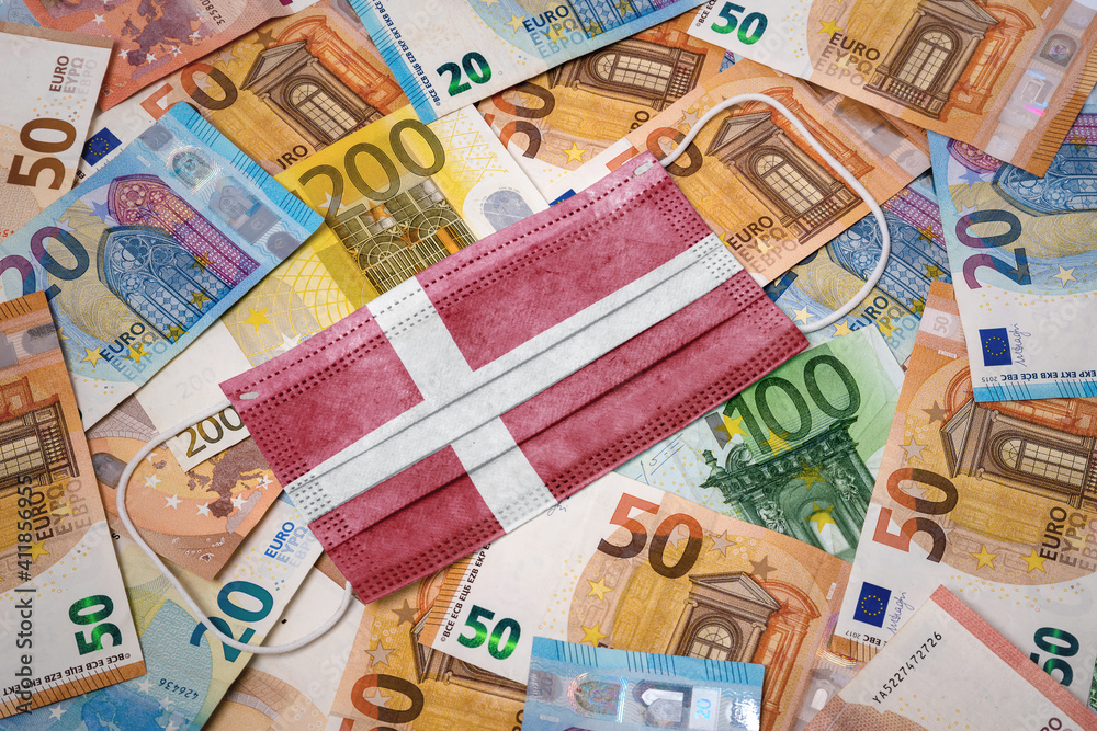 Medical mask with the flag of Denmark on a variety of european banknotes.(series) Medical mask with the flag of Denmark on a variety of european banknotes.(series)