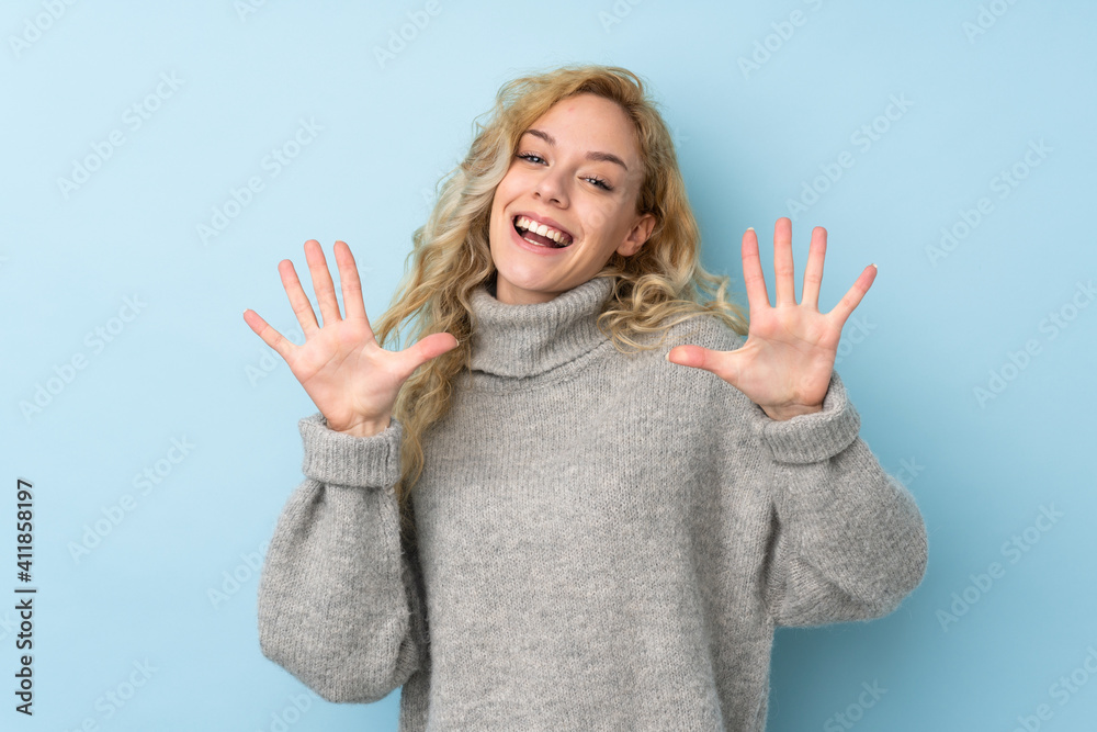 Young blonde woman wearing a sweater isolated on blue background counting ten with fingers Young blonde woman wearing a sweater isolated on blue background counting ten with fingers