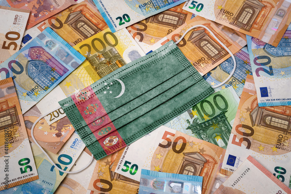 Medical mask with the flag of Turkmenistan on a variety of european banknotes.(series) Medical mask with the flag of Turkmenistan on a variety of european banknotes.(series)