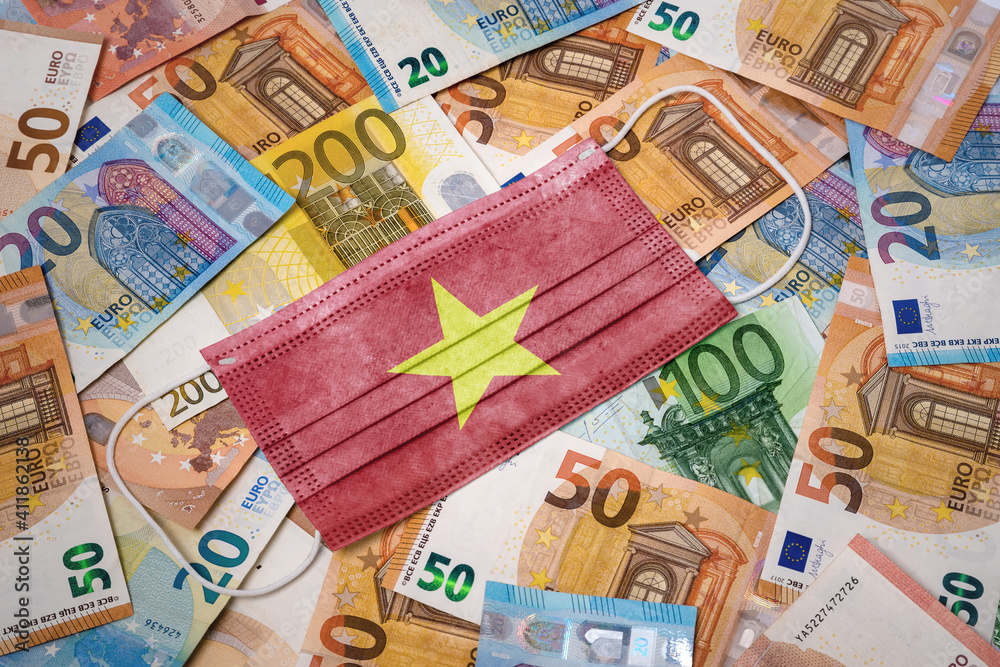 Medical mask with the flag of Vietnam on a variety of european banknotes.(series) Medical mask with the flag of Vietnam on a variety of european banknotes.(series)