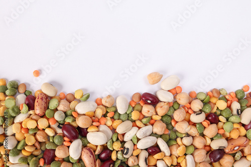 Mixed beans multi grain colorful mixture horizontal line frame border copy text space on white background photo