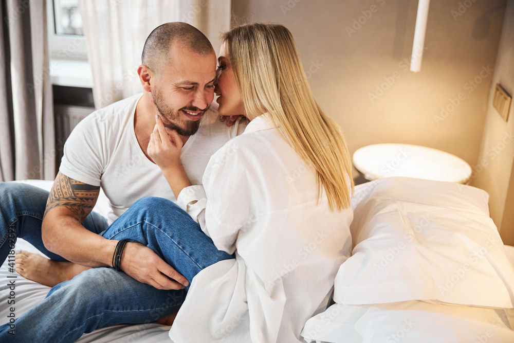Woman whispering something in her husband ear