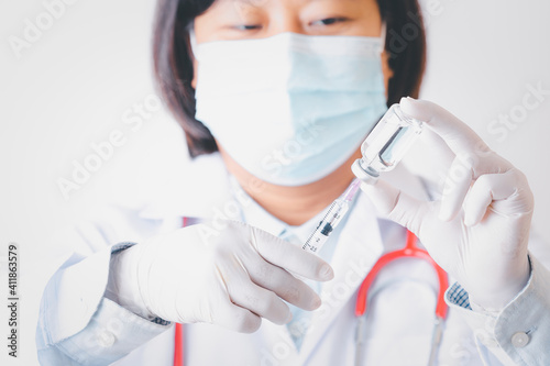 dortor woman or scientist in laboratory hands in gloves holding syringe and vaccine coronavirus vial dose flu shot drug infection concept of vaccination, injection medicine. photo