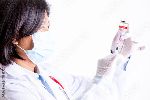 dortor woman or scientist in laboratory hands in gloves holding syringe and vaccine coronavirus vial dose flu shot drug infection concept of vaccination, injection medicine. photo