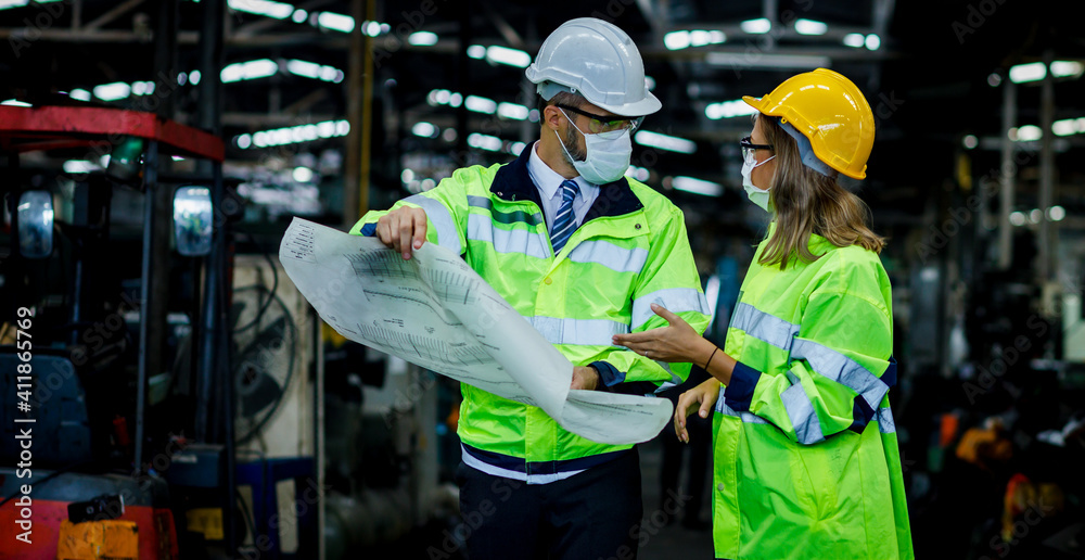 Engineer or architect is walk in site store factory. They are check the location from the blueprint and Maintenance plan and discussing or explaning the plan to renovate. Engineer or architect is walk in site store factory. They are check the location from the blueprint and Maintenance plan and discussing or explaning the plan to renovate.
