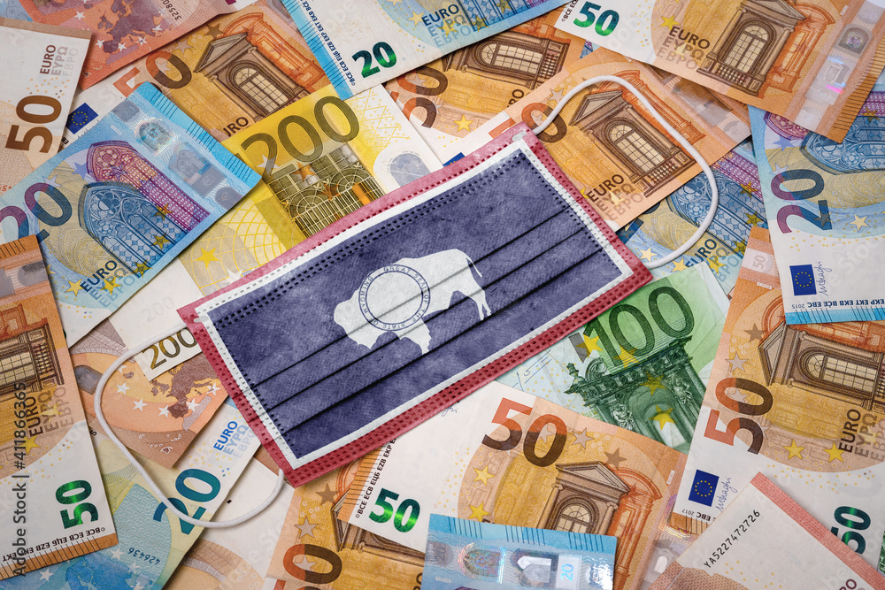 Medical mask with the flag of Wyoming on a variety of european banknotes.(series) Medical mask with the flag of Wyoming on a variety of european banknotes.(series)