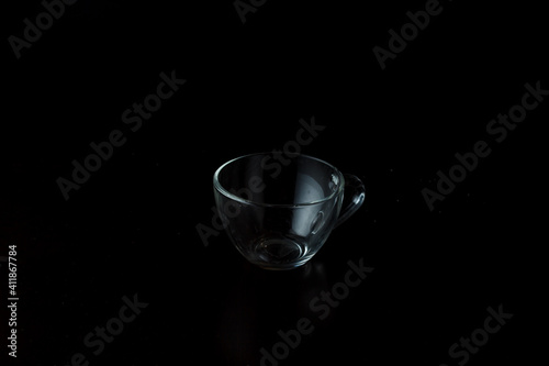 transparent glass cup on a dark background.