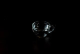 transparent glass cup with water on a dark background. drink in a cup on the table.