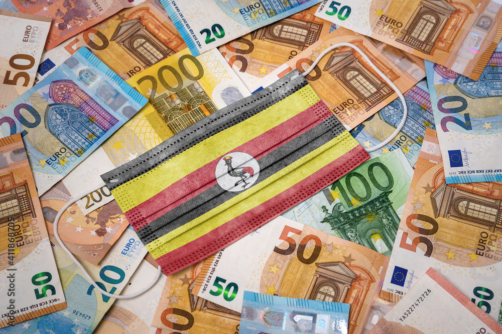 Medical mask with the flag of Uganda on a variety of european banknotes.(series) Medical mask with the flag of Uganda on a variety of european banknotes.(series)