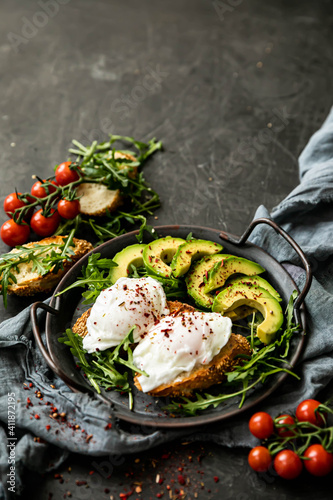 breakfast egg with avocado and herbs. Vertical orient