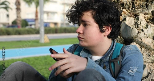 Serious Offended Young Boy Looking At The Camera at the outdoors