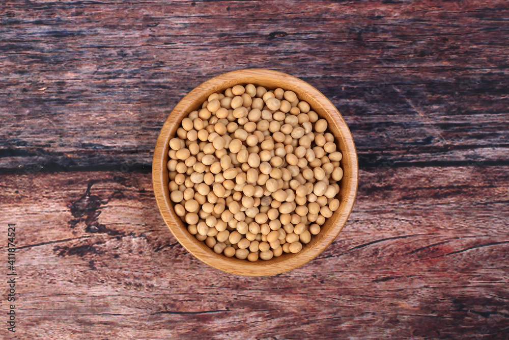 Soya bean in wooden bowl on rustic wood background Soya bean in wooden bowl on rustic wood background