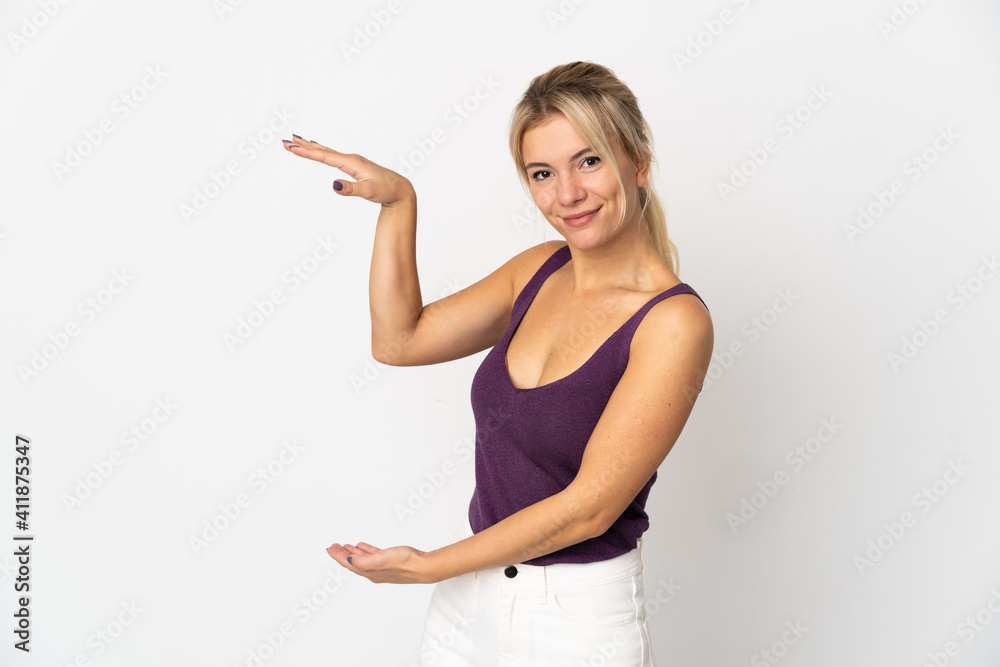 Young Russian woman isolated on white background holding copyspace to insert an ad Young Russian woman isolated on white background holding copyspace to insert an ad
